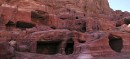 Tombs in Mountainside * Many remains of tombs, carved into the red rock in the center of Petra.  Tombs like these cover almost all of the rock walls within Petra.     * 864 x 396 * (119KB)